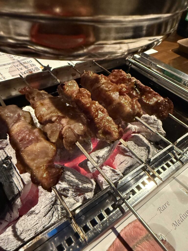 Lamb skewers grilling over charcoal at Iga Ne Jamsil