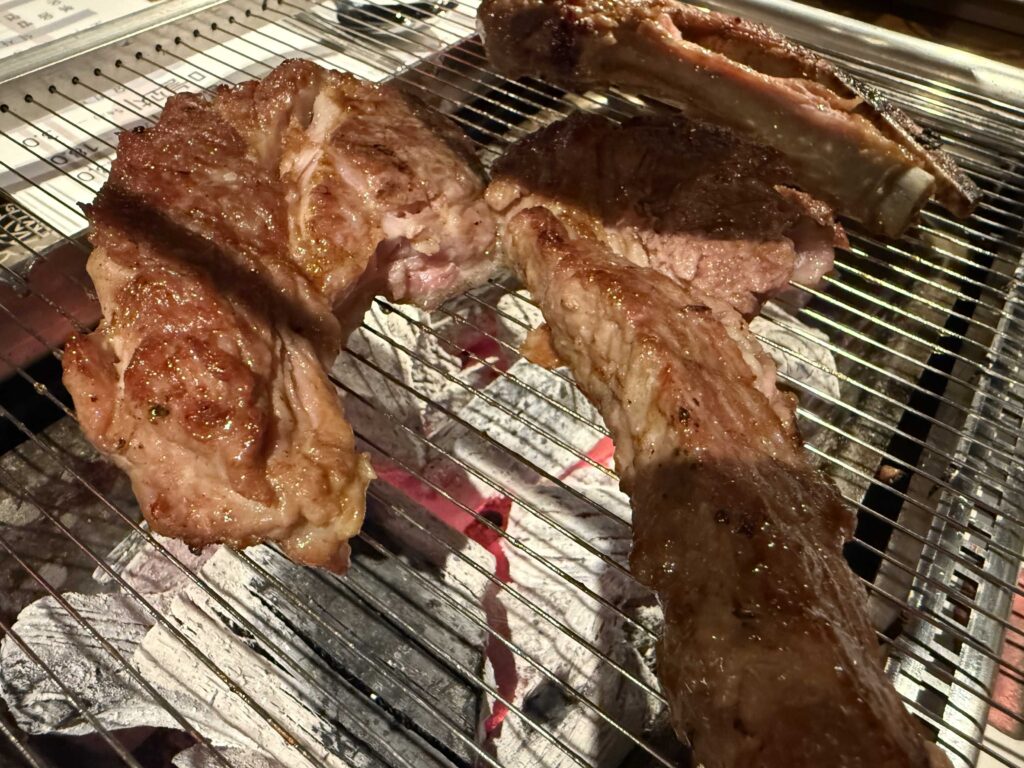 Thick-cut lamb ribs sizzling on the grill