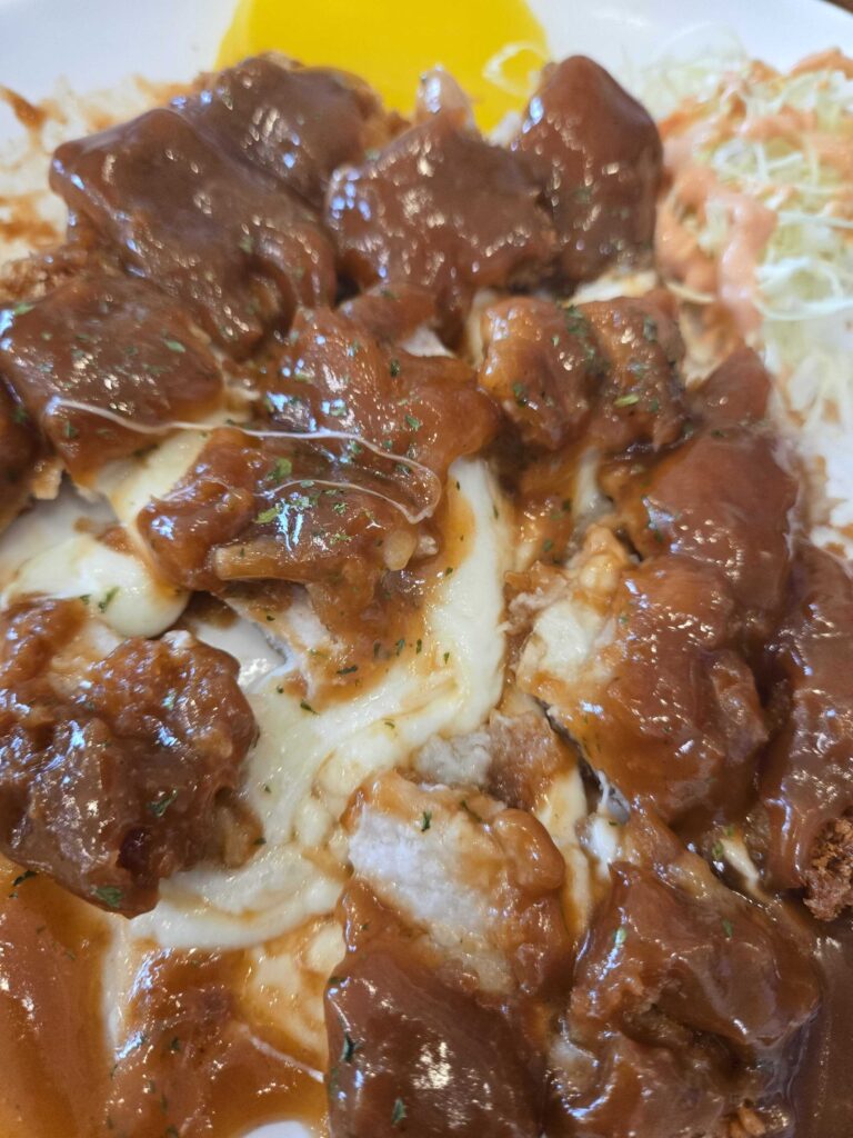 Cheese donkasseu at Park Seung-gwang Haemul Kalguksu with rich brown sauce