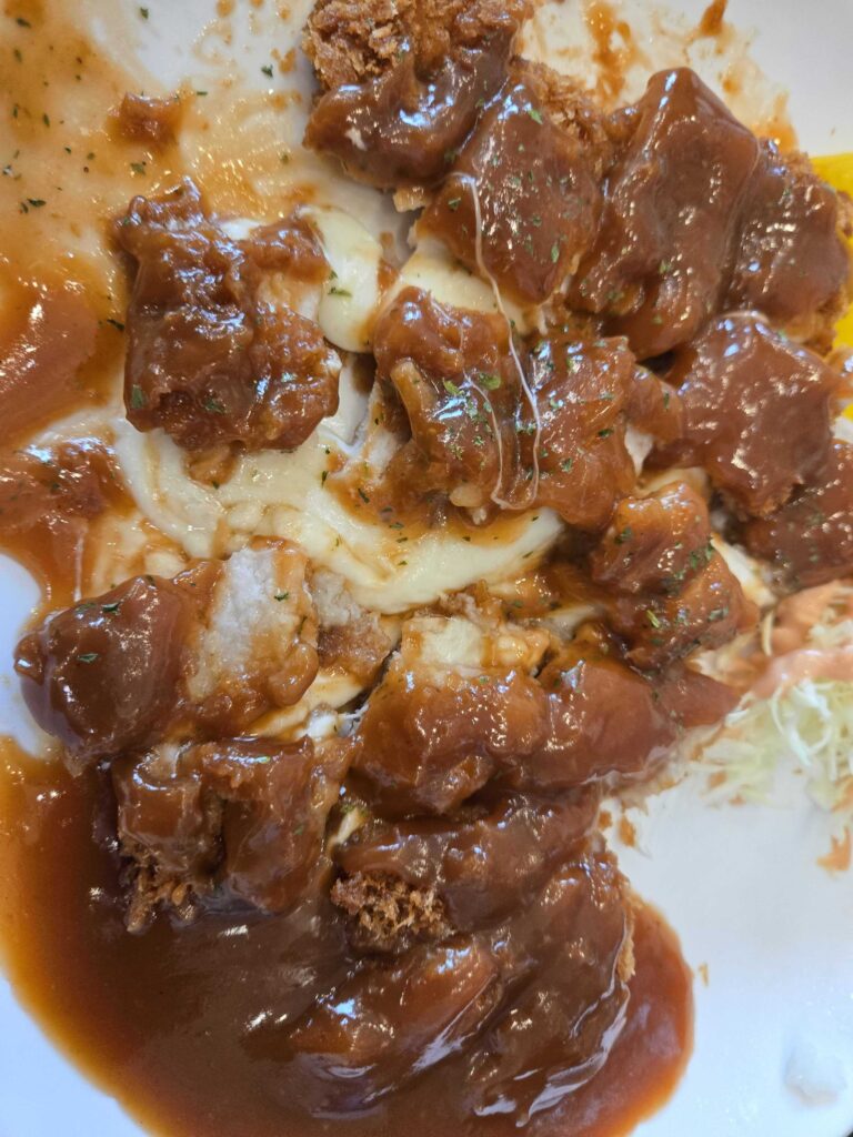 Close-up of cheese donkasseu at Park Seung-gwang Haemul Kalguksu