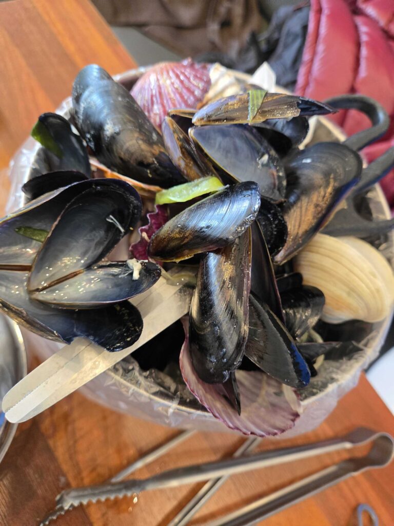 Bowl full of empty mussel and scallop shells after finishing the kalguksu