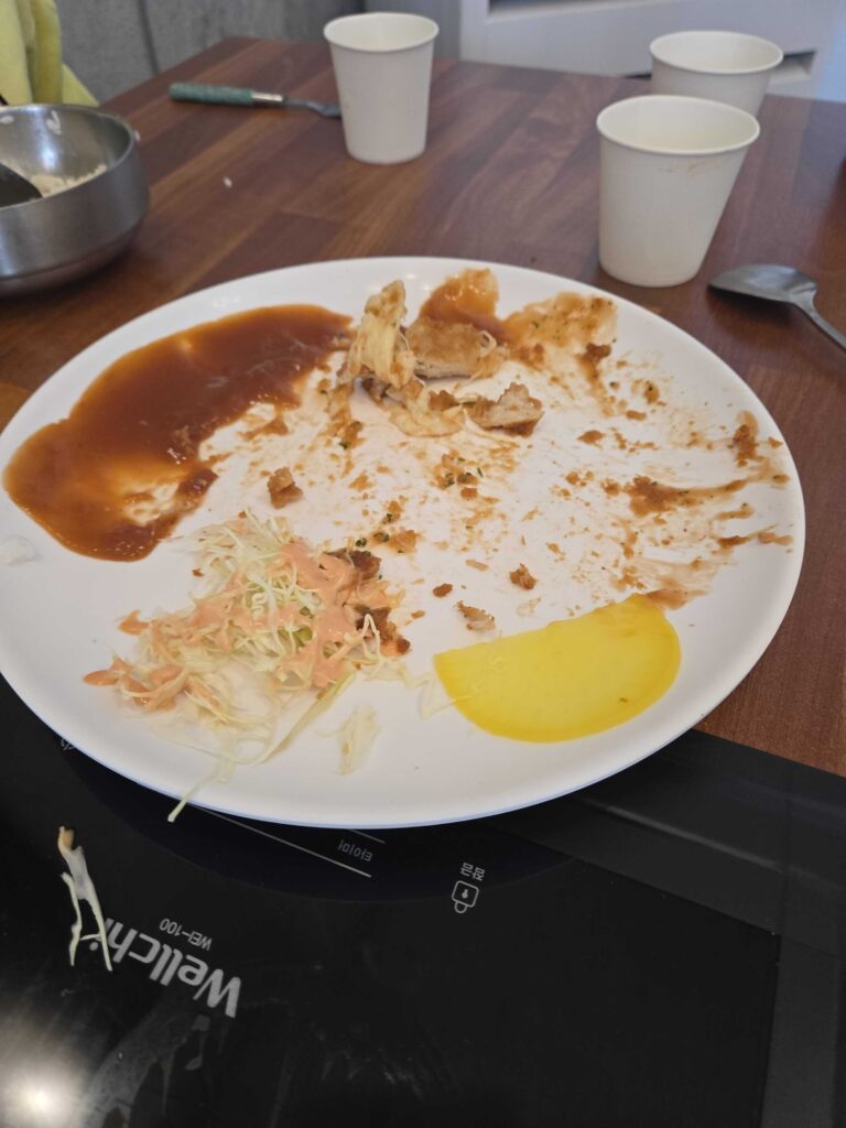 Cleaned donkasseu plate after eating at Park Seung-gwang Haemul Kalguksu
