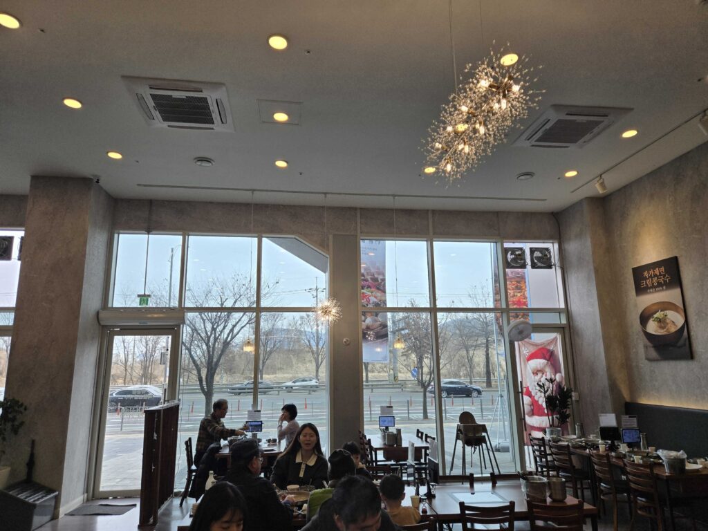 Bright interior of Park Seung-gwang Haemul Kalguksu with large windows