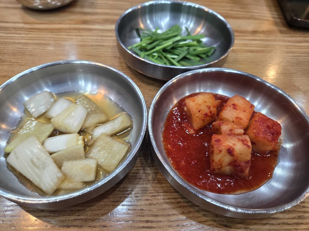 Banchan side dishes at Dammion Seongsu including pickled radish and kimchi