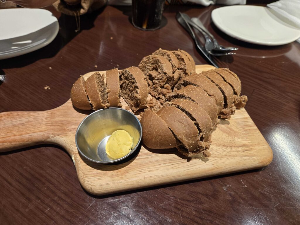 Complimentary bread basket served with chocolate syrup dipping sauce