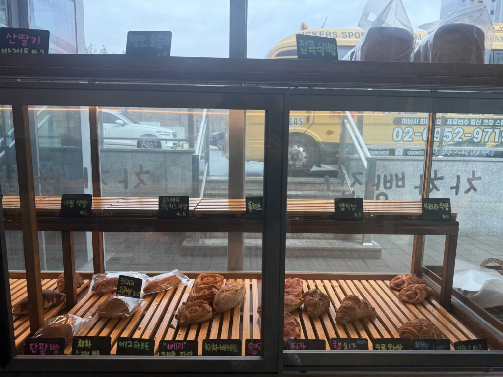 Full bread display case with variety of baked goods