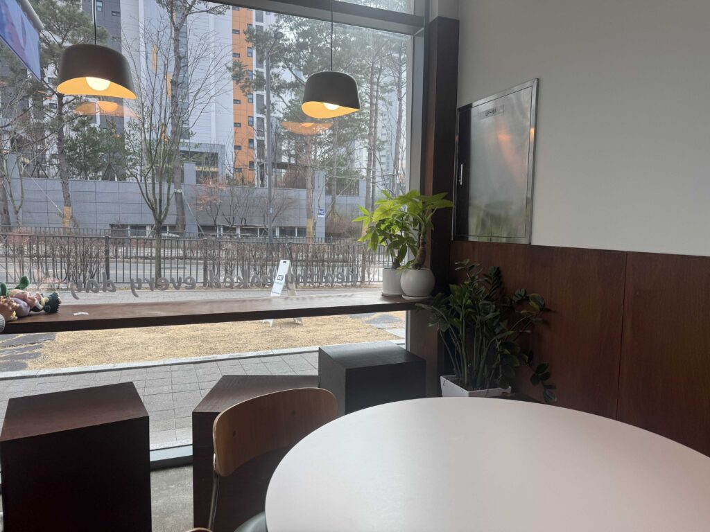 Interior seating with round tables and warm lighting