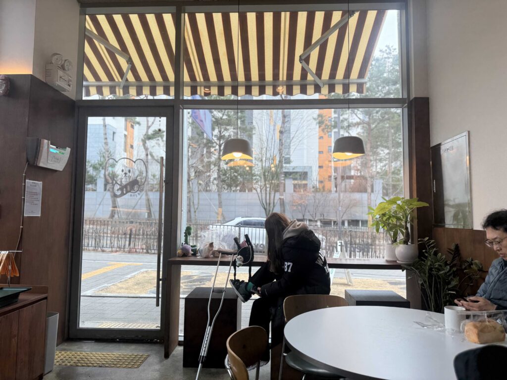 Wide view of bakery interior with customers enjoying bread