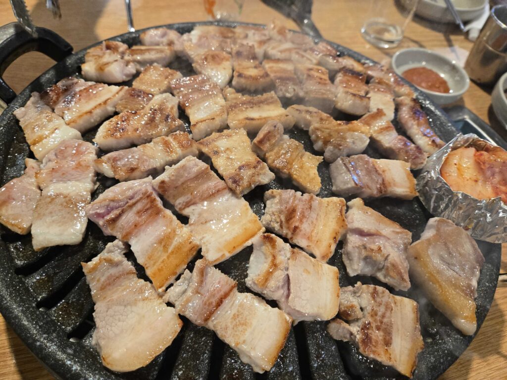 Full banchan spread at Mongttang Saenggogi including kimchi gosari namul lettuce and bean sprout side dishes