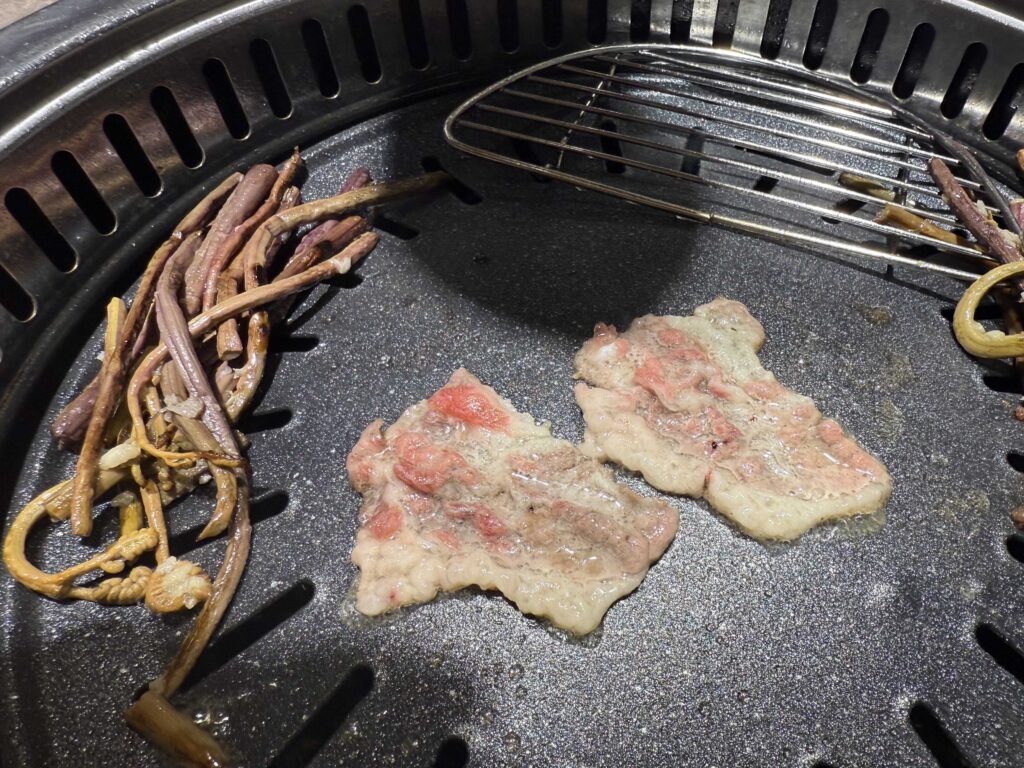 Marinated pork and fernbrake on the grill at Geobugi Dongnae Hanam