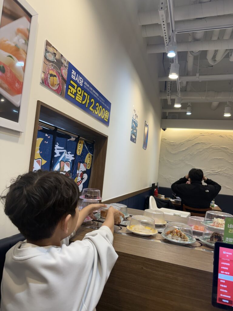 Sushi plates on conveyor belt Gamil Choice Hanam close-up