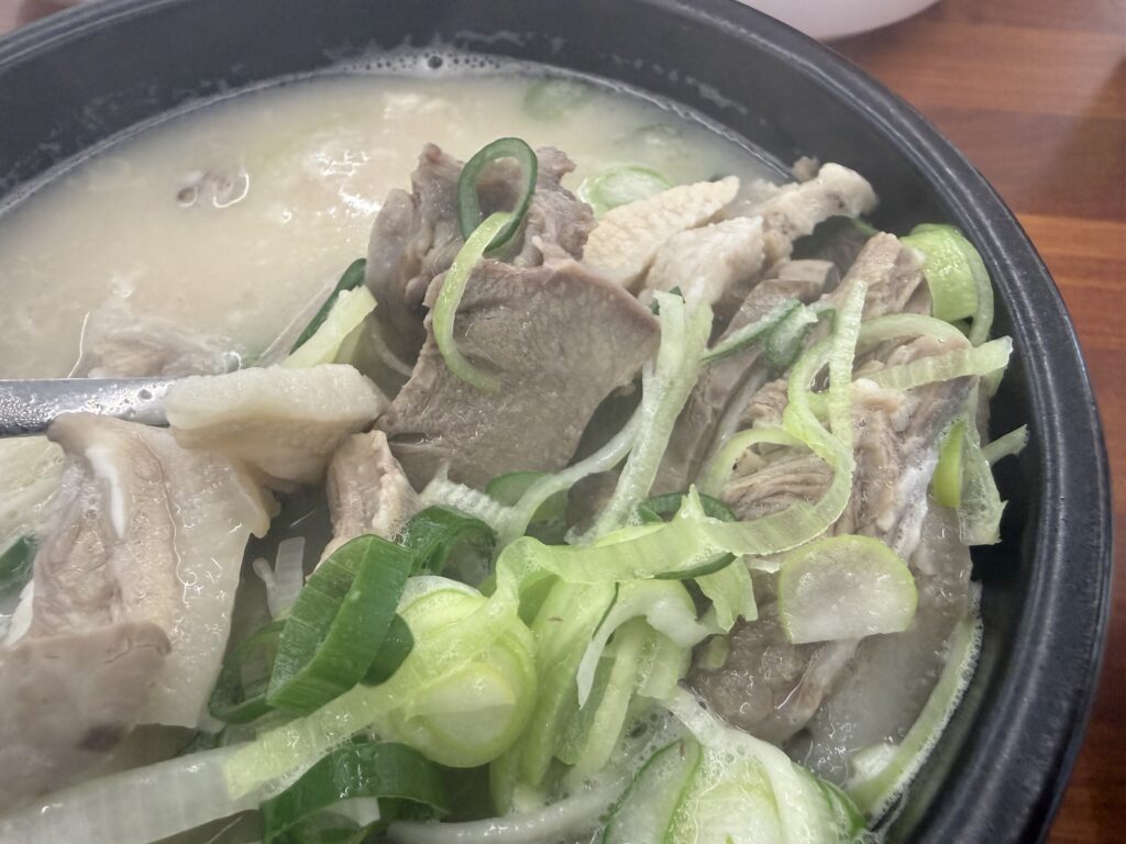 Sokcho Dalbit-e Goeun Sundaeguk pork pieces green onion bowl close-up