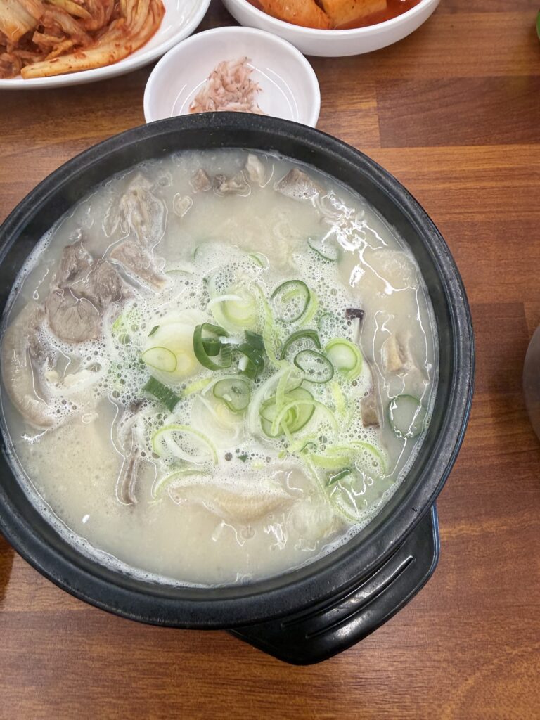 Sokcho Dalbit-e Goeun Sundaeguk bowl milky pork bone broth green onion banchan kimchi