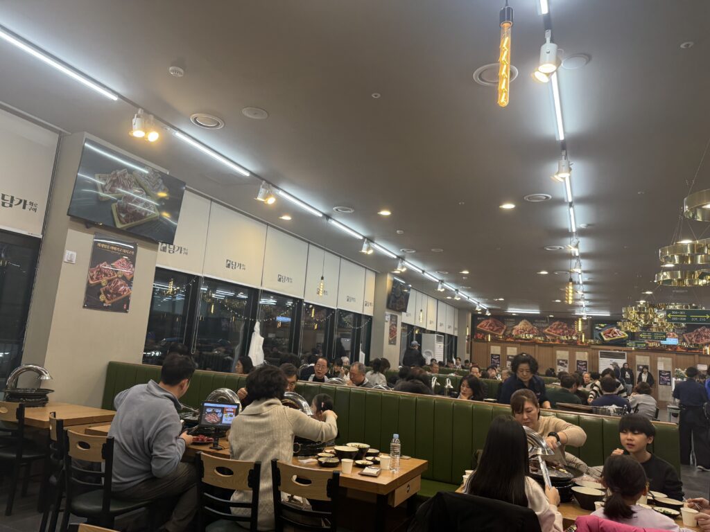 Packed interior of Damga Hwaro Grill Gamil branch with rows of booths
