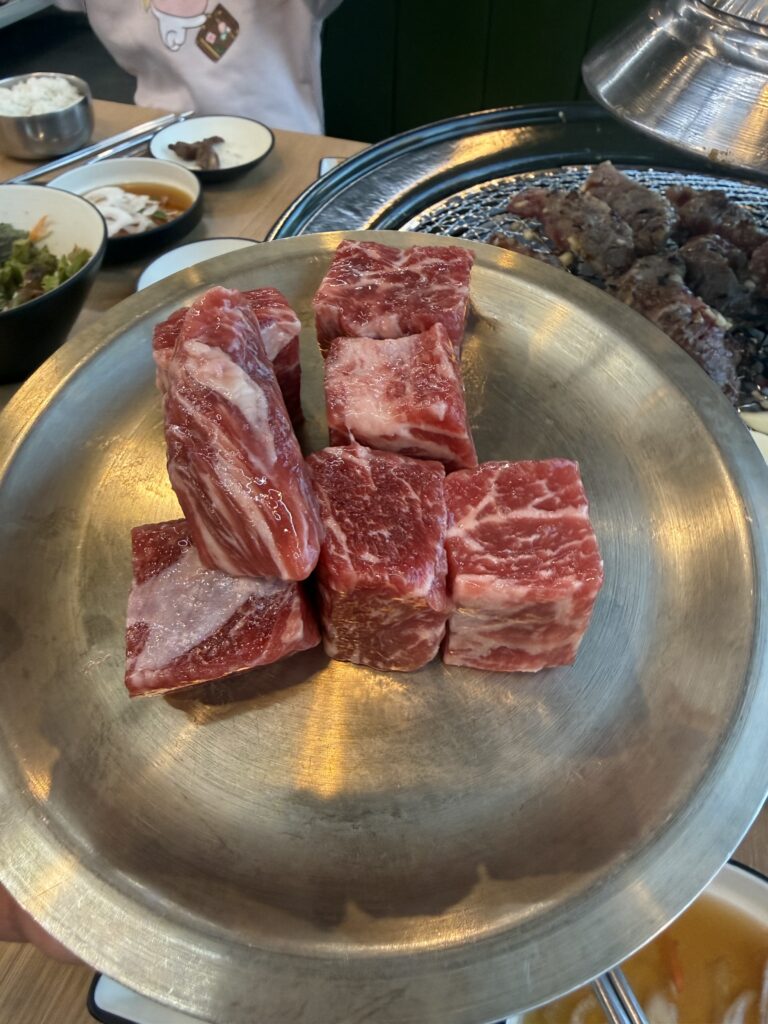 Beautifully marbled premium beef cuts on plate at Damga Hwaro Grill