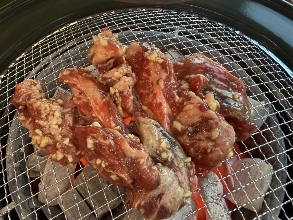 Marinated galbi beef ribs grilling on charcoal at Damga Hwaro