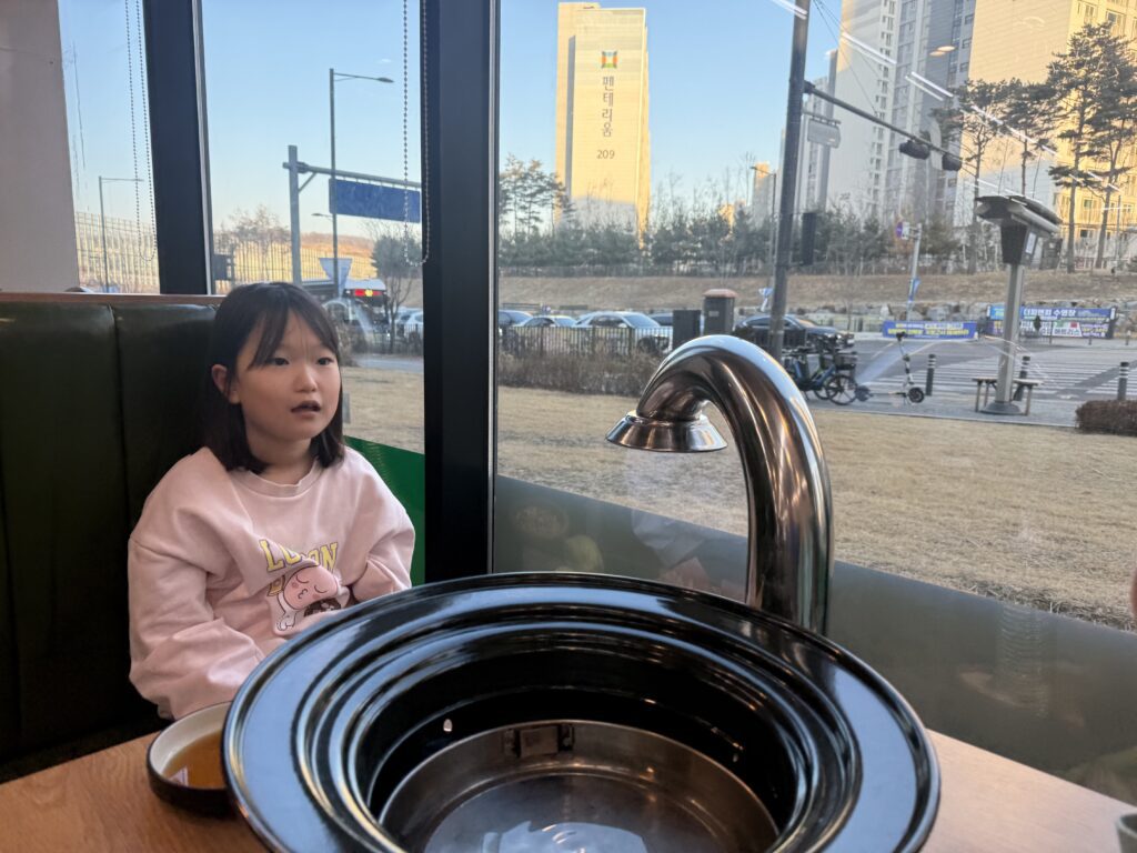 Child excited at Korean BBQ table at Damga Hwaro Grill Gamil
