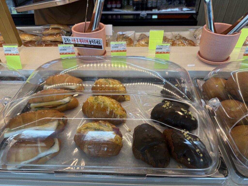 Bread display at Ganghyeon Bakery Cafe croissants and buns