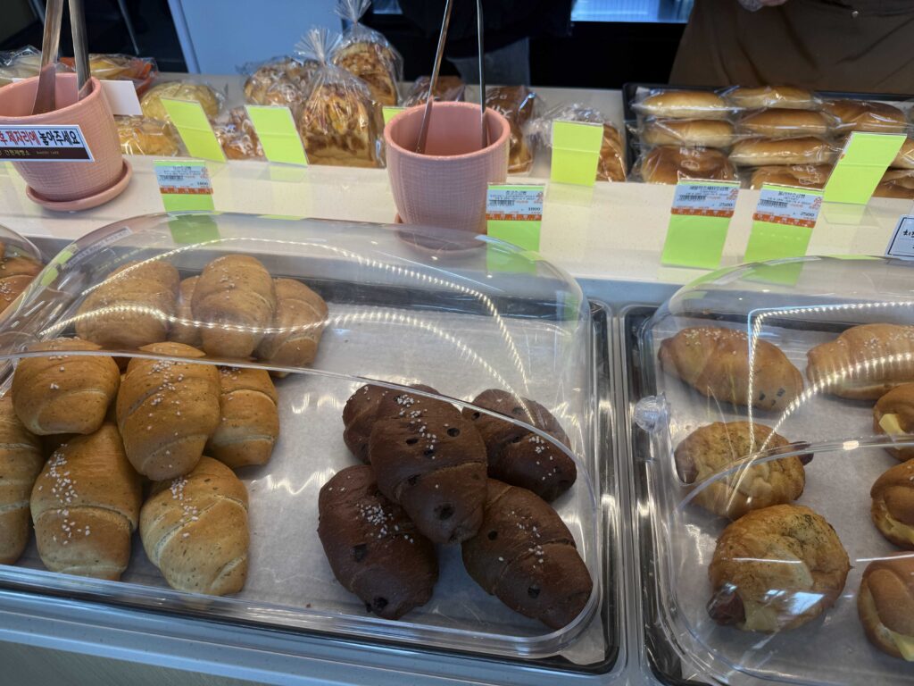 Bakery display with various sweet and savory buns at Ganghyeon