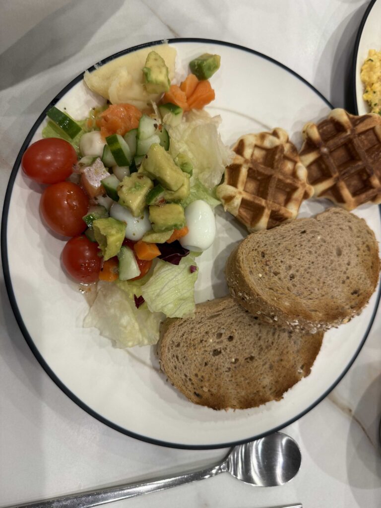 Completed breakfast plate at Oak Valley Resort waffle salad bread sausage