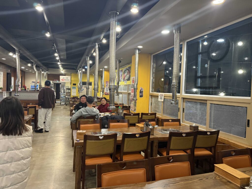 Mannajeong Wonju interior dining hall warm lighting Korean BBQ restaurant