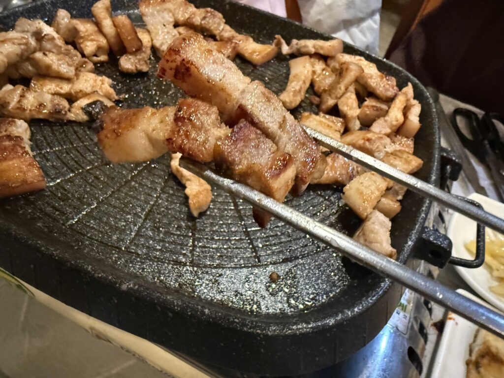Crispy samgyeopsal pork belly on grill with kimchi Mannajeong restaurant