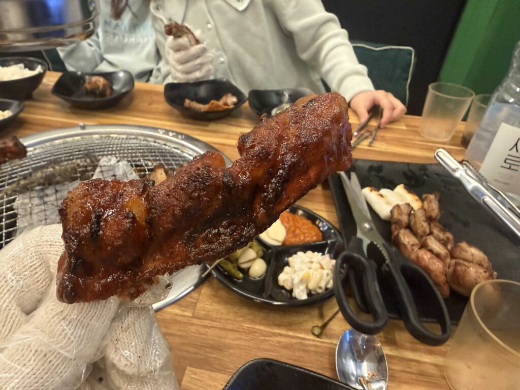 Yangnyeom seasoned jjokgalbi pork ribs grilling on charcoal at Jjokgalbi Gamil