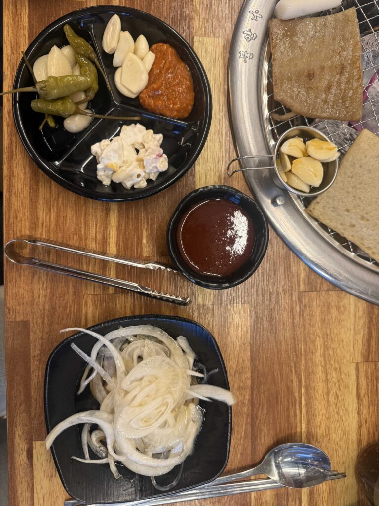 Overhead view of a complete Korean BBQ pork rib dinner spread