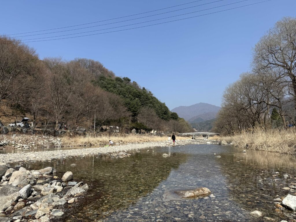 Stream view with mountains in the background at the camping site