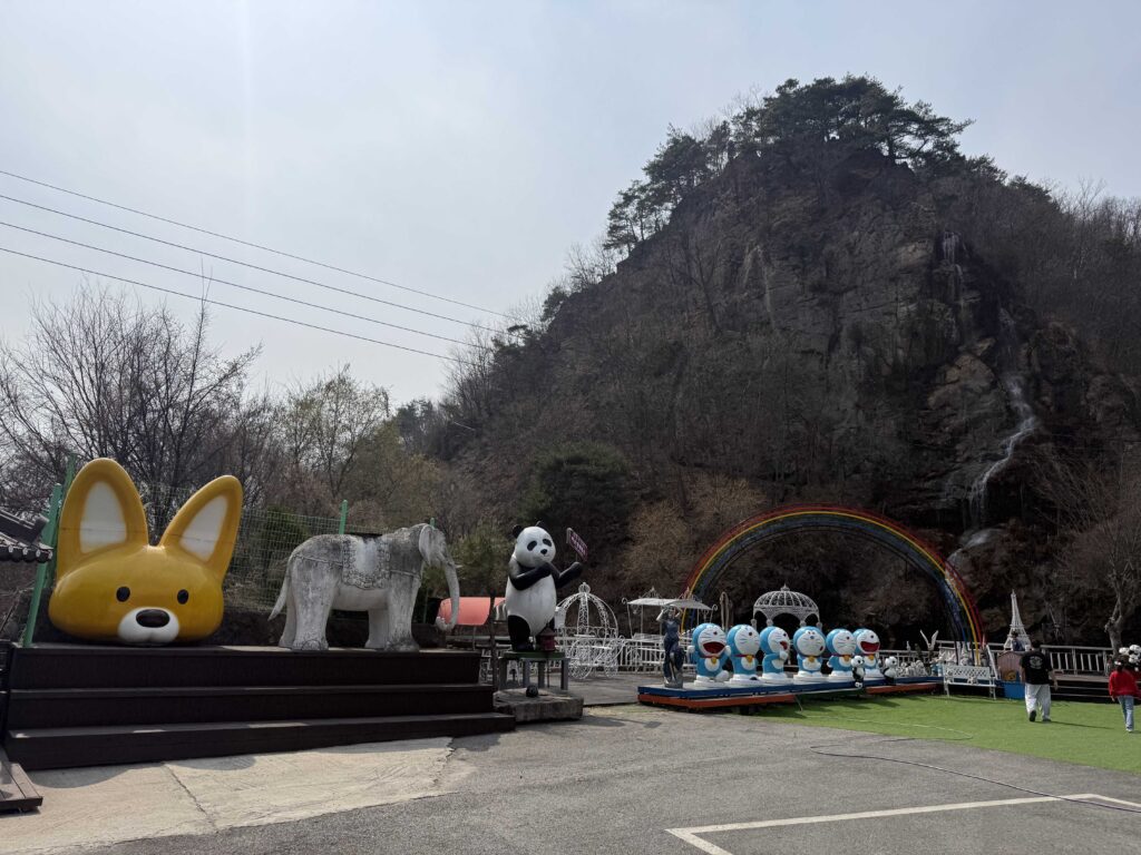 Colorful character statues with Doraemon figures at Baegundang Bakery outdoor area
