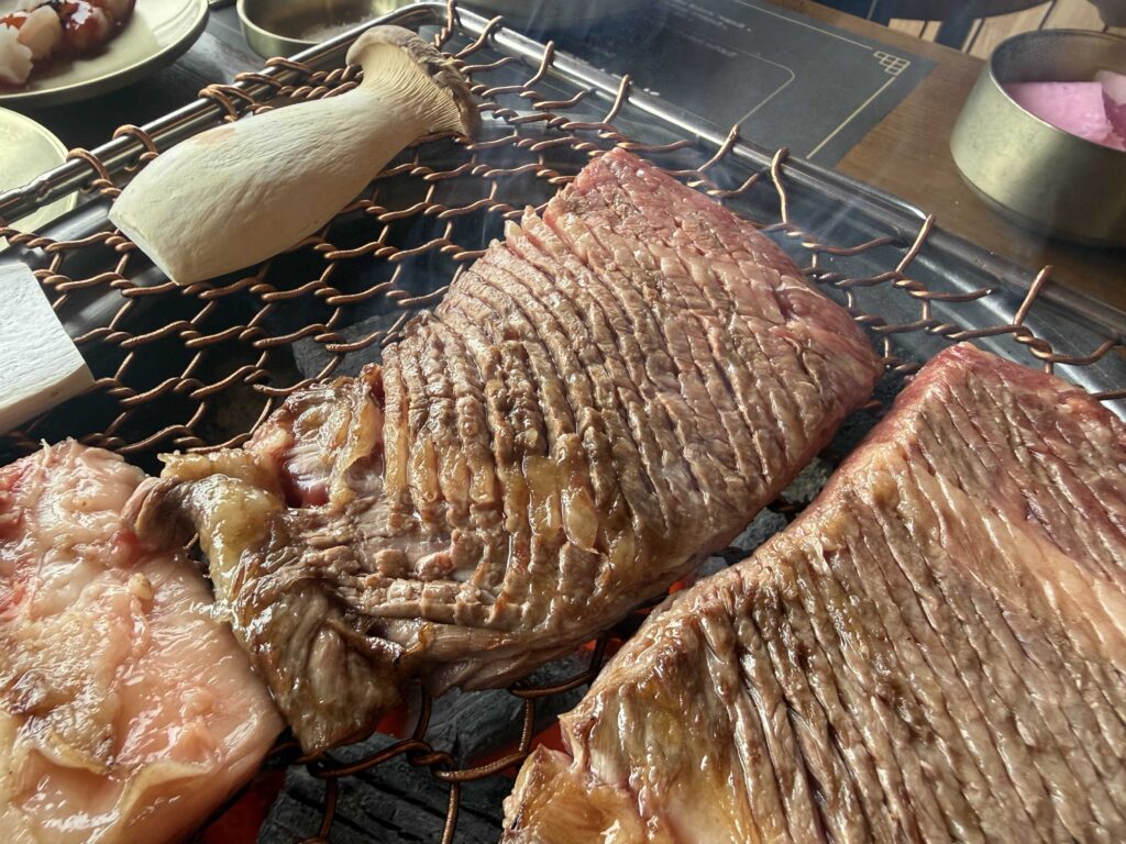 Marinated galbi ribs cooking on the grill