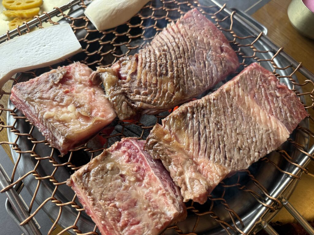 Bone-in Korean galbi ribs on charcoal fire