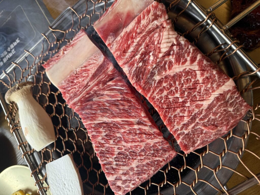 Raw marbled beef ribs on the charcoal grill