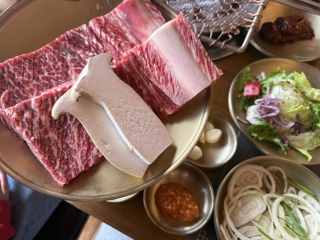 Raw galbi with beautiful marbling on a brass plate