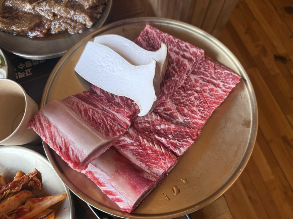 Raw galbi and kimchi on the BBQ plate