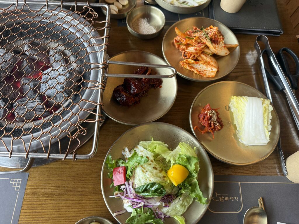 Table spread with grill kimchi salad and dipping sauce
