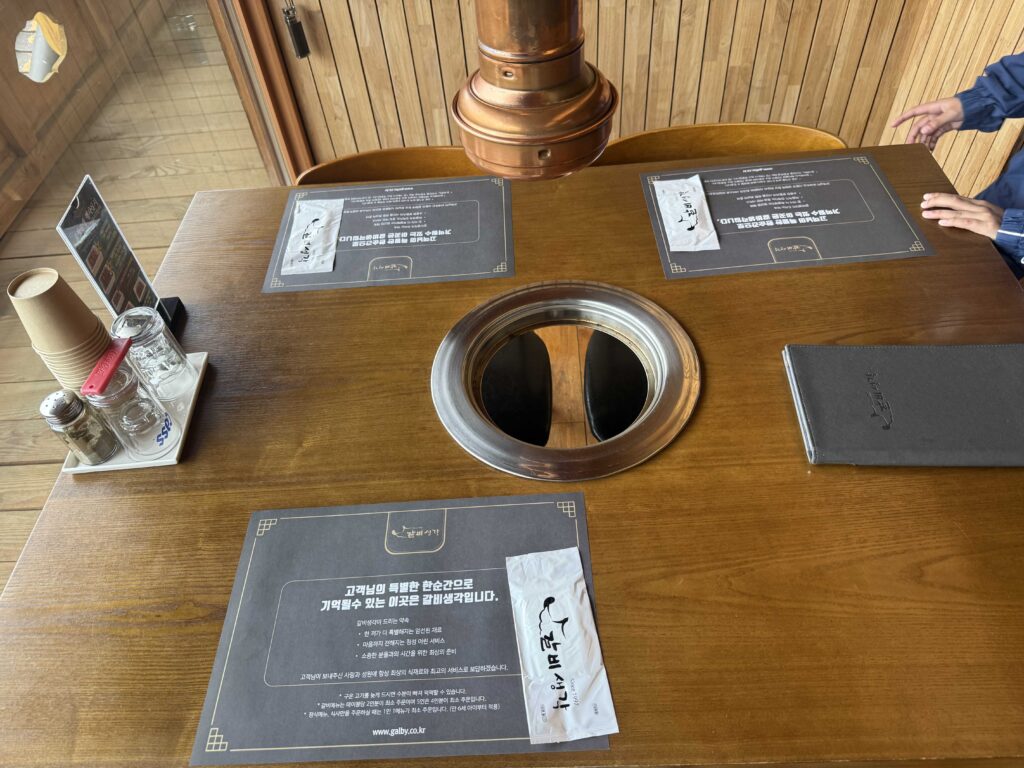 Table setup with branded placemat and charcoal grill
