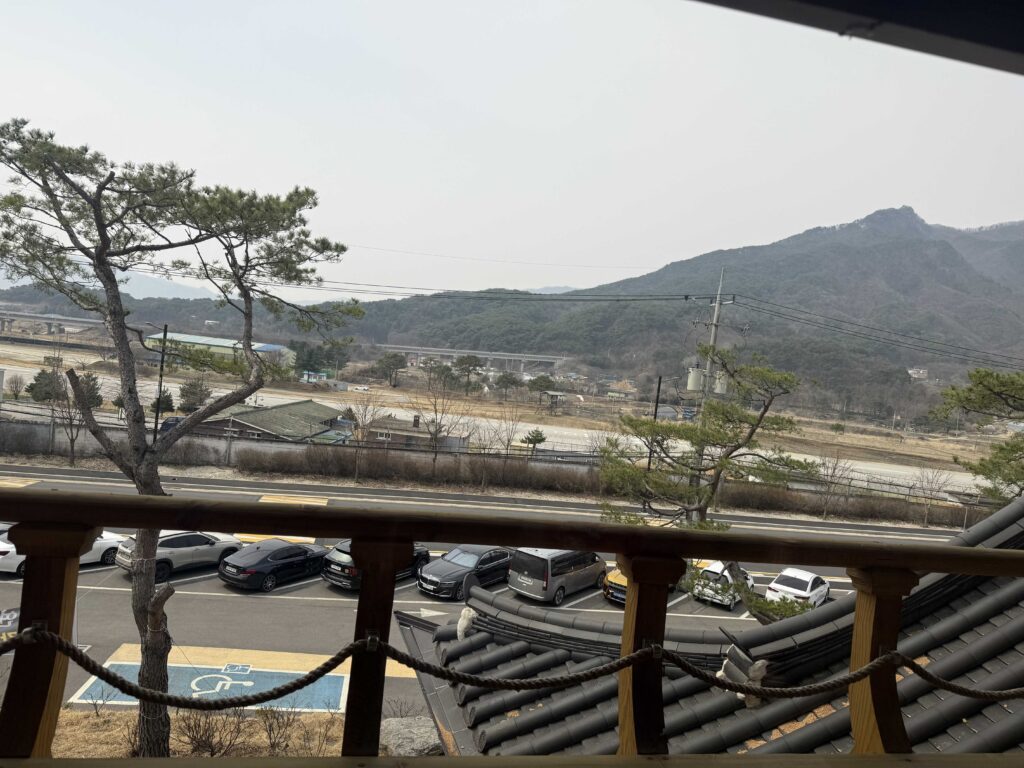 Balcony overlooking pine trees and mountains in Pocheon