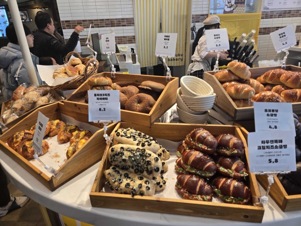 Okuku Bakery full bread display at Starfield Hanam with salt bread croissants bagels and signature items