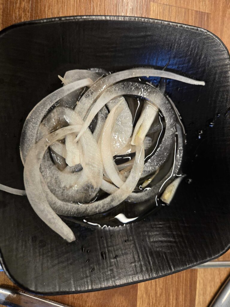 Free tteok rice cakes and side dishes served with Korean BBQ