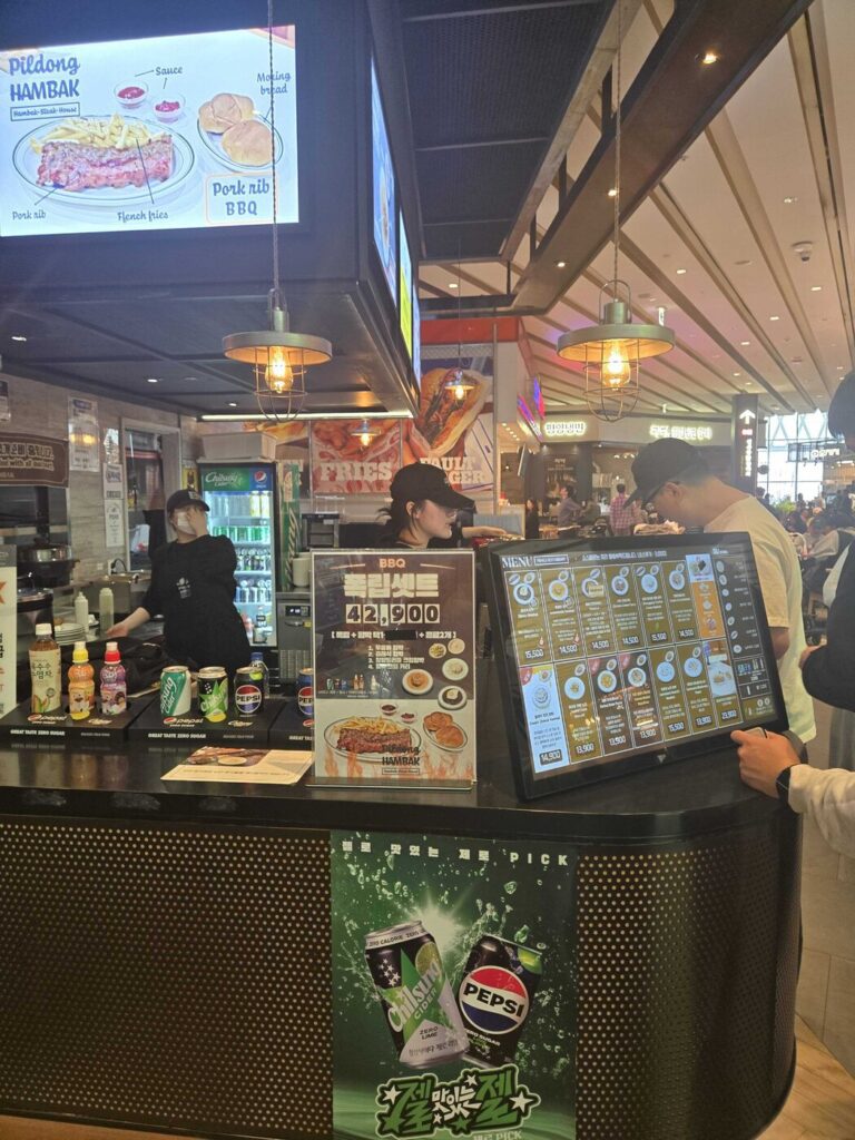 The counter with the menu screen and a BBQ rib set sign