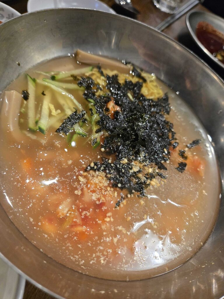 Mul naengmyeon (물냉면) cold buckwheat noodles with cucumber and nori — a classic Korean BBQ ender