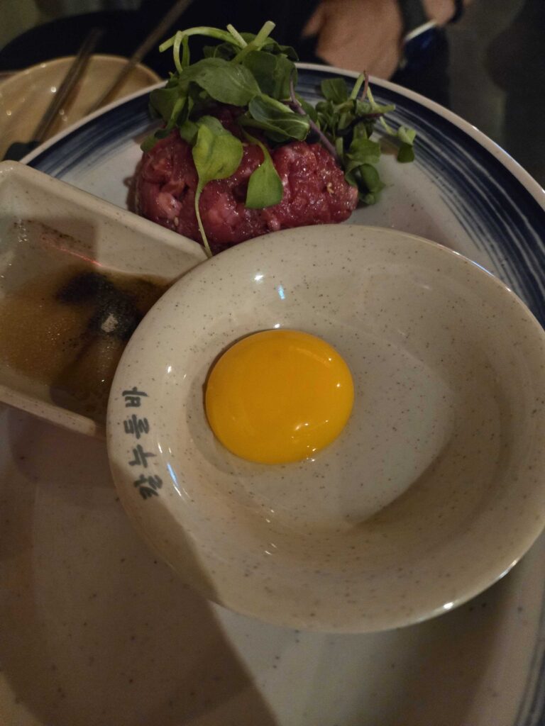 Close up of yukhoe beef tartare with egg yolk at the restaurant