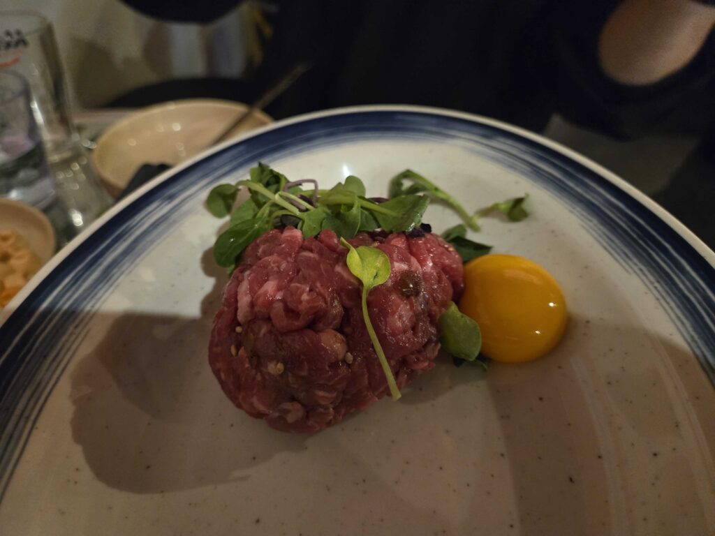 Yukhoe Korean beef tartare mixed with egg yolk close up shot