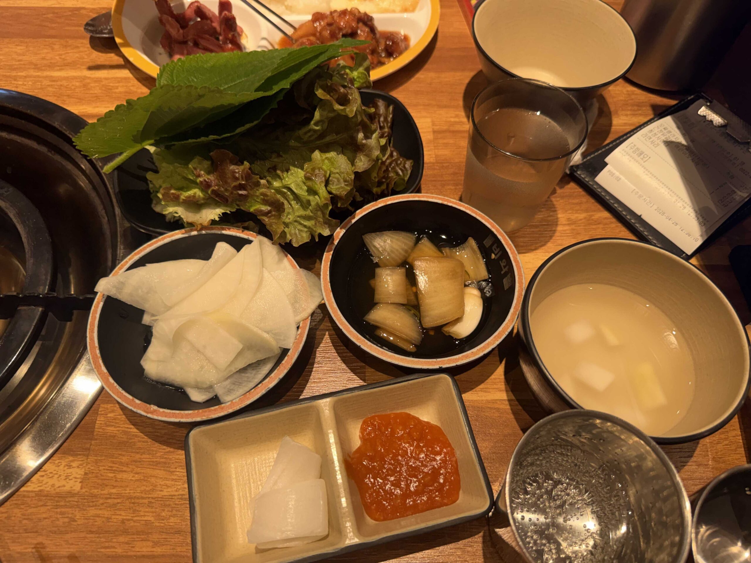 Biwabyul Dakgalbi Wirye banchan side dishes with lettuce wraps, pickled radish, and ssamjang