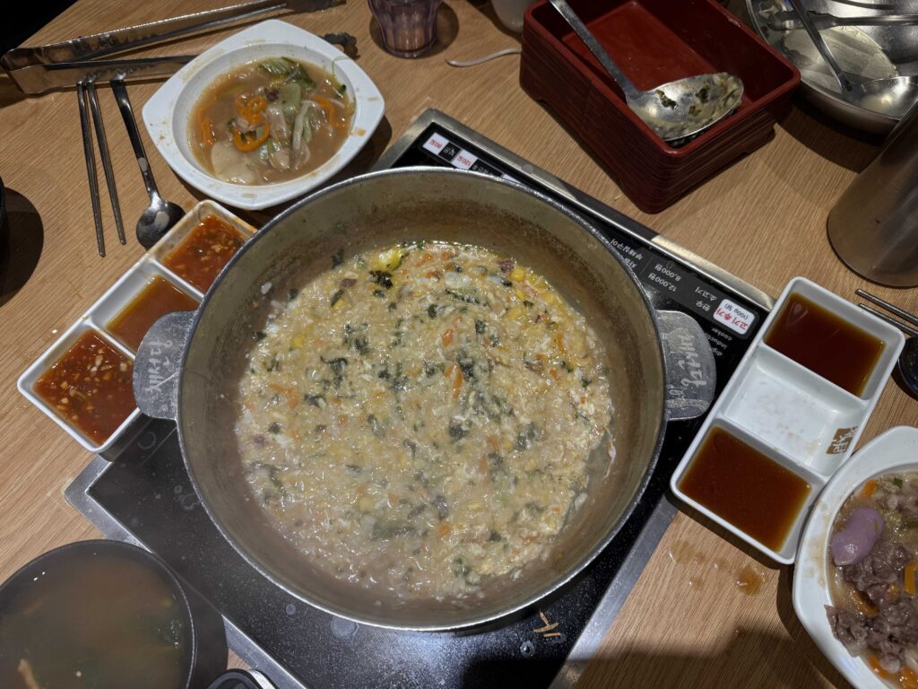 Porridge cooking in the leftover broth