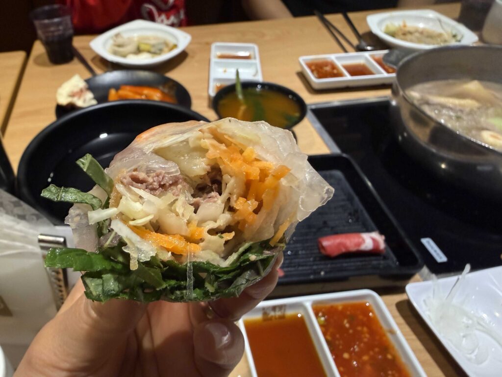 A spring roll with beef and vegetables