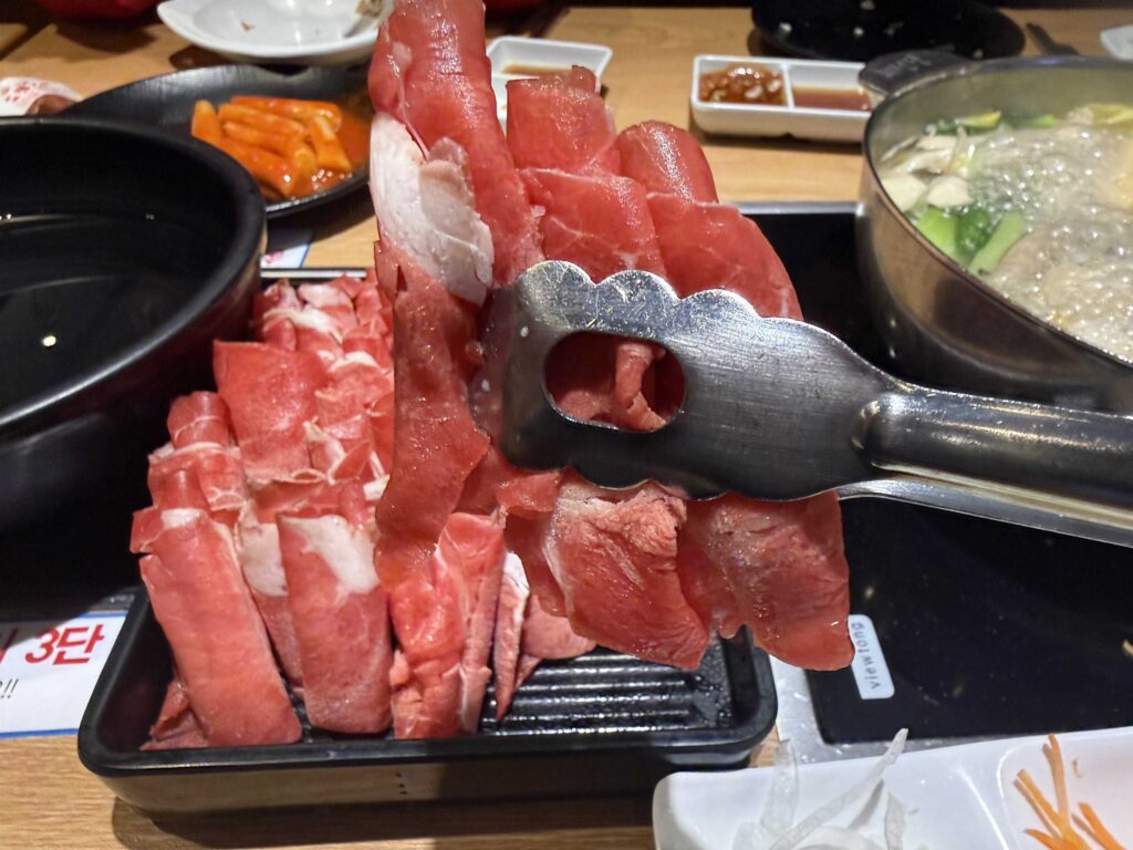 Thin slices of beef ready for the pot