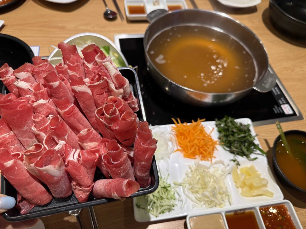 Plates of beef next to the pot