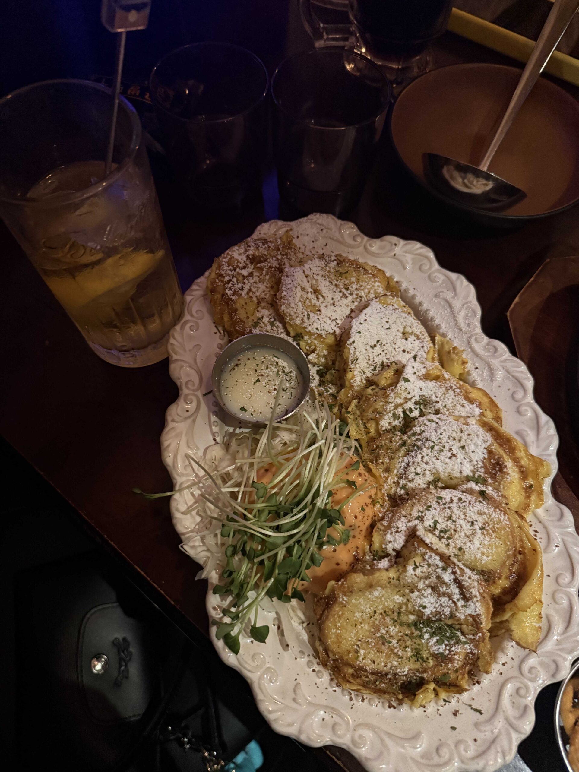 Sweet french toast dusted with powdered sugar served with cream dip at Geumbyeol Maekju Bangi